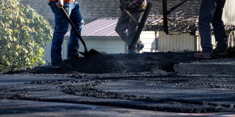 Construction,Workers,In,Safety,Gear,With,Shovels,And,Asphalt,Rakes