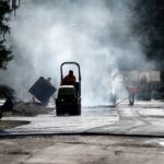 Residential,Street,Repaving,Project,,Silhouetted,Steamroller,Compacting,And,Smoothing,New