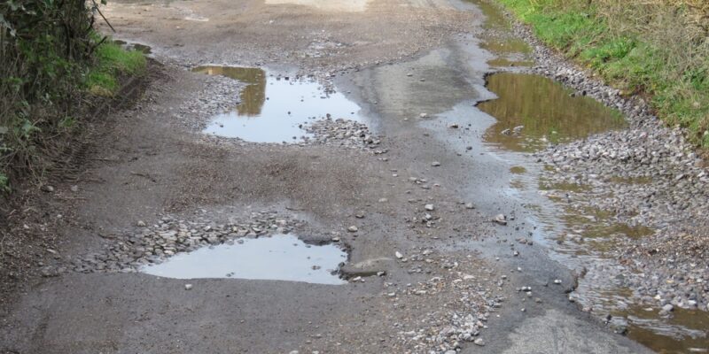 Pots,Holes,In,A,Narrow,Country,Lane